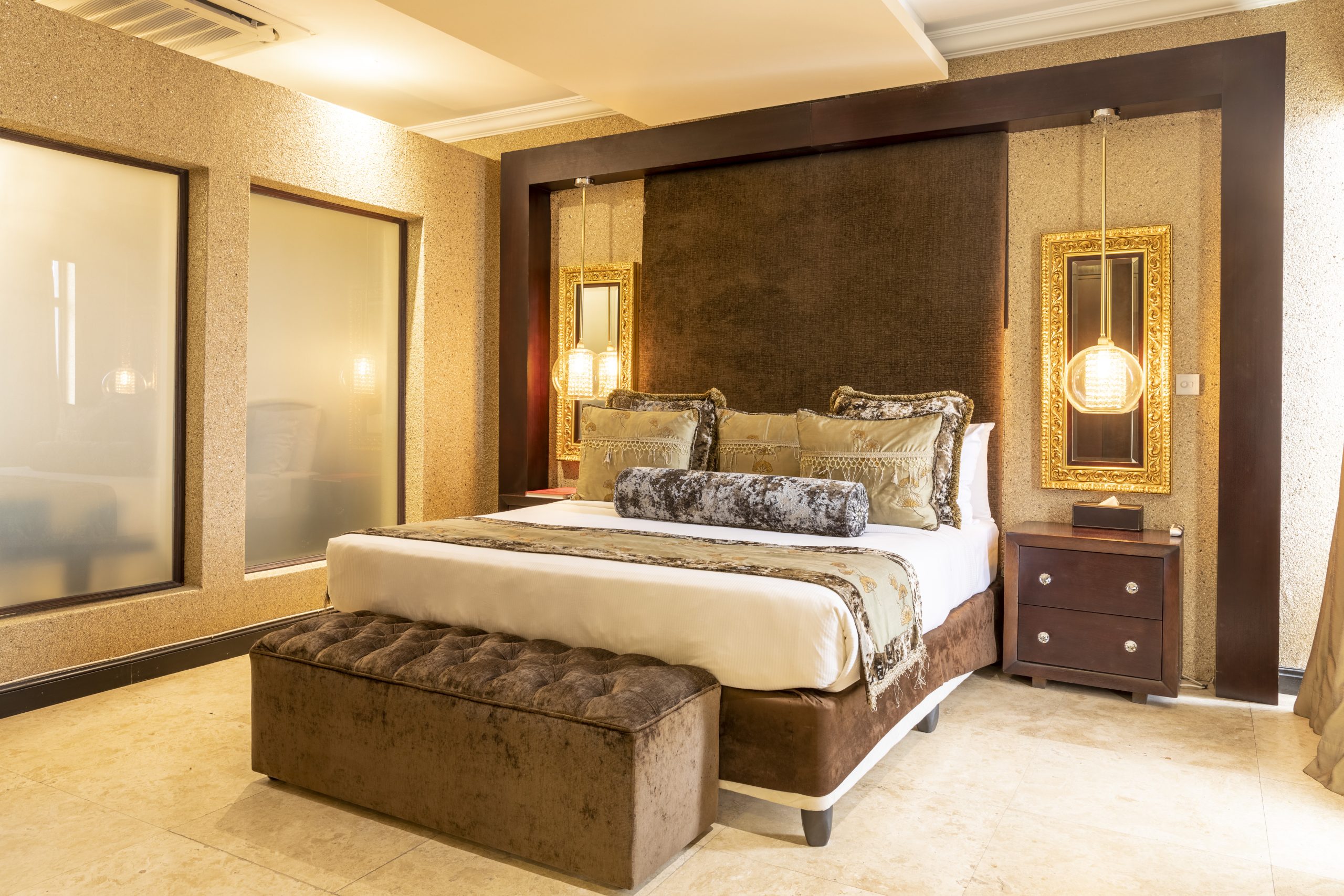 Kwame Nkrumah Presidential Suite bed area showcasing an elegant king-sized bed with luxurious linens, sophisticated decor, and tasteful furnishings, creating a plush and inviting atmosphere.
