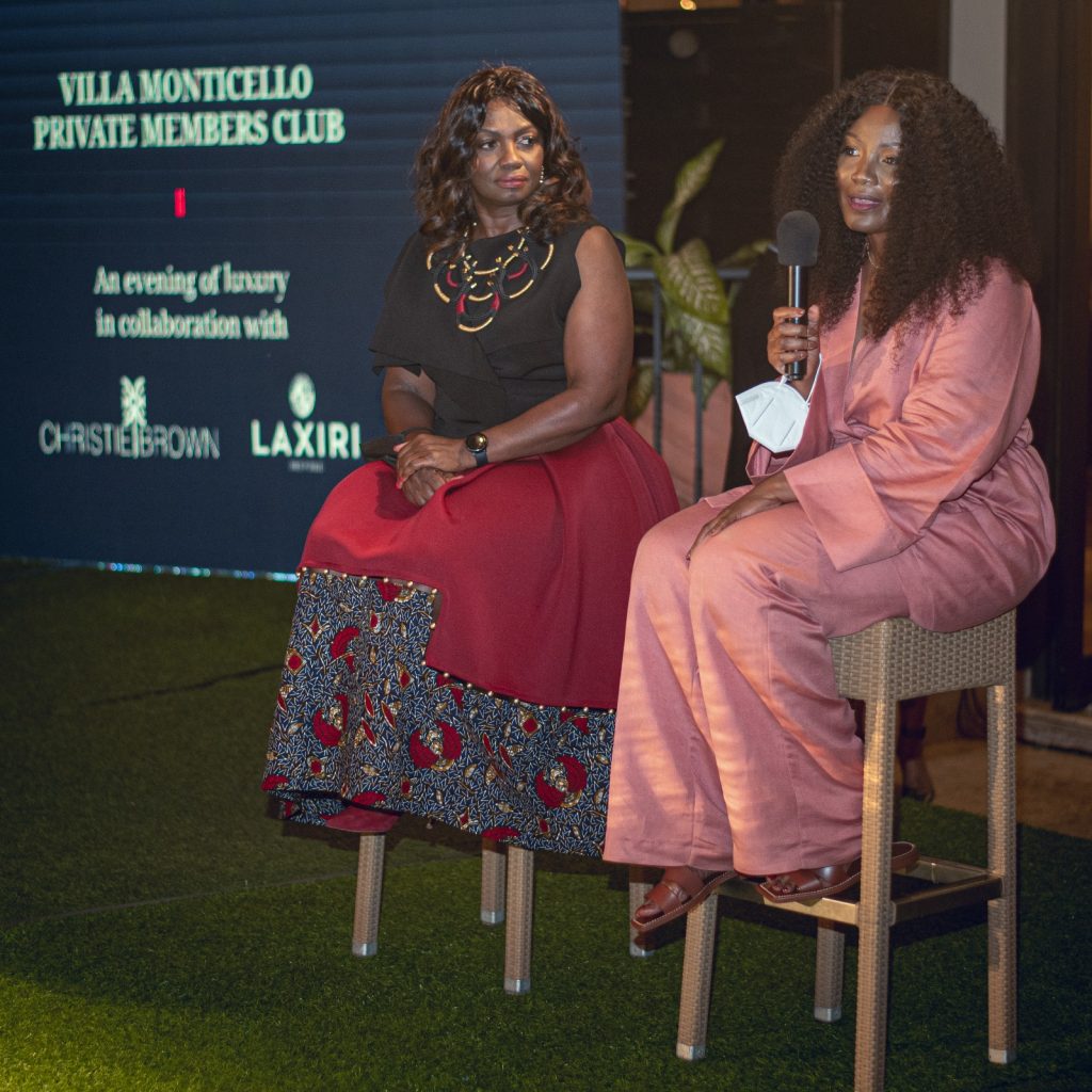 Two women seated together in a private members club, enjoying each other's company against an elegant backdrop.